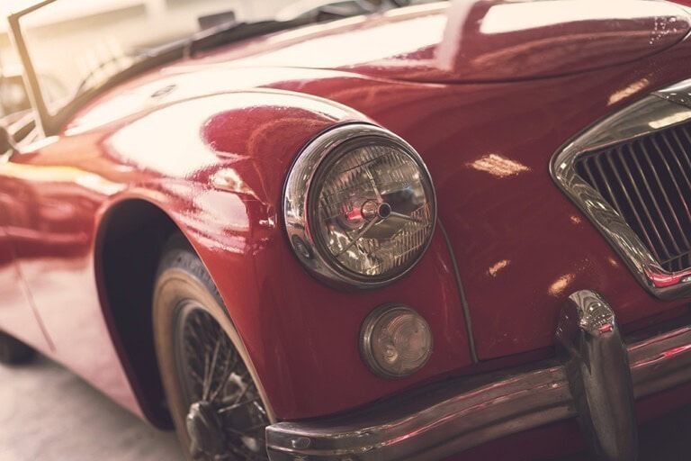 close up headlight of red retro classic car 2023 11 27 05 28 46 utc 768x512
